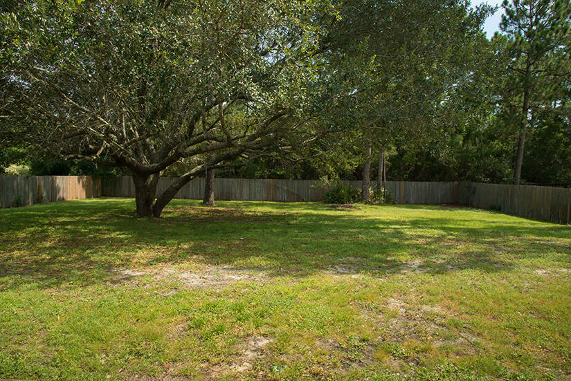 6805 Fernandina Road Navarre, FL 32566 - Photo 25 of 29 a view of a house with a yard