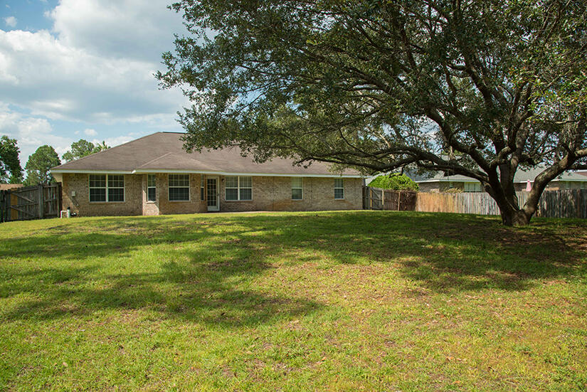 6805 Fernandina Road Navarre, FL 32566 - Photo 26 of 29 a front view of house with yard and green space