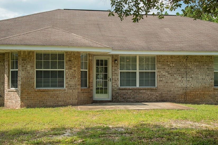 6805 Fernandina Road Navarre, FL 32566 - Photo 27 of 29 a front view of a house with a yard