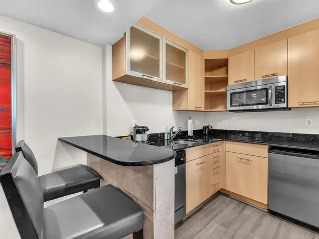 a kitchen with stainless steel appliances granite countertop a sink and stove top oven
