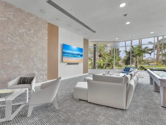 a living room with furniture a rug and a large window