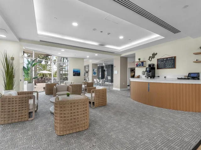 a living room with furniture and view of kitchen