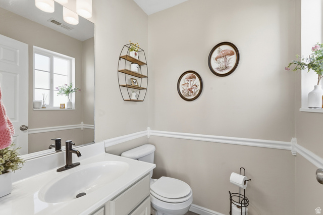99 Penhurst Place Logan, UT 84341 - Photo 14 of 34 Bathroom featuring a single vanity with an integrated sink, dark bronze-finish faucet, and a large wall-mounted mirror
