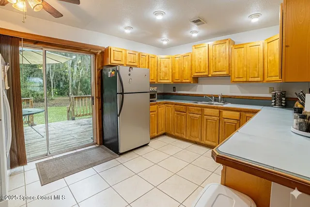 a kitchen with stainless steel appliances granite countertop a refrigerator and a sink