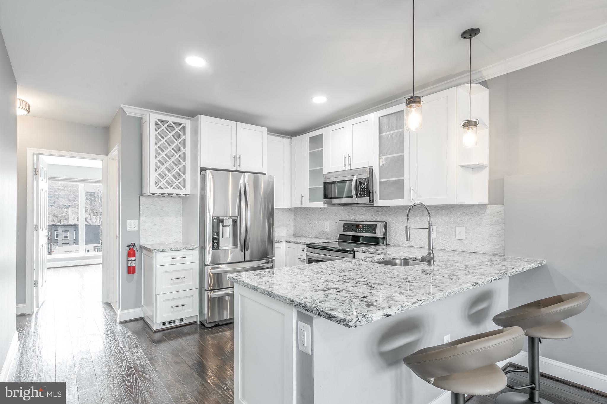 29 Q Street Northeast, Unit 2 Washington, DC 20002 - Photo 8 of 28 Soft close cabinets, wine storage.