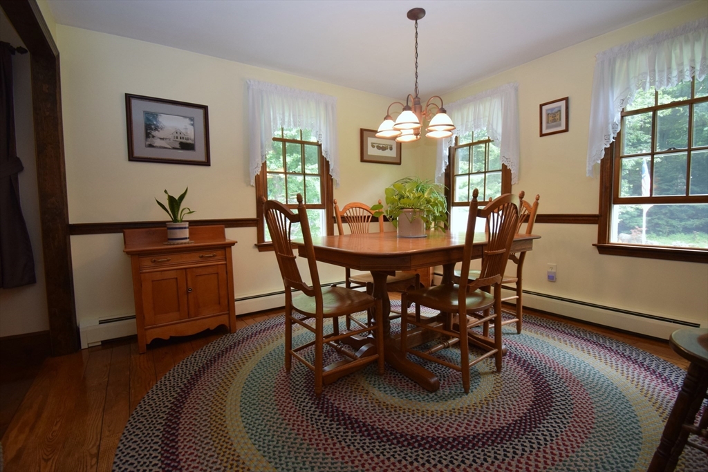 91 Ball Road Kingston, NH 03848 - Photo 8 of 42 a dining room with furniture a window and wooden floor