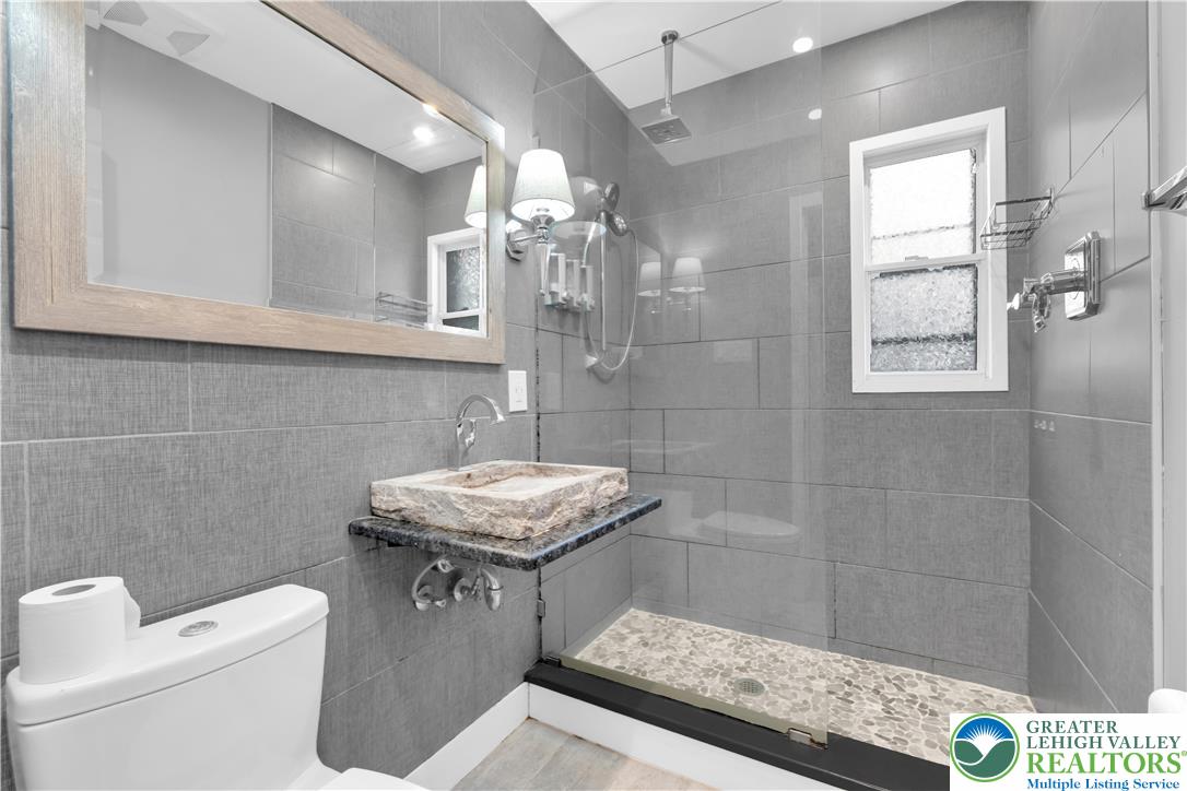 1942 Greenleaf Street Bethlehem, PA 18017 - Photo 22 of 41 a bathroom with a sink a toilet a mirror and shower