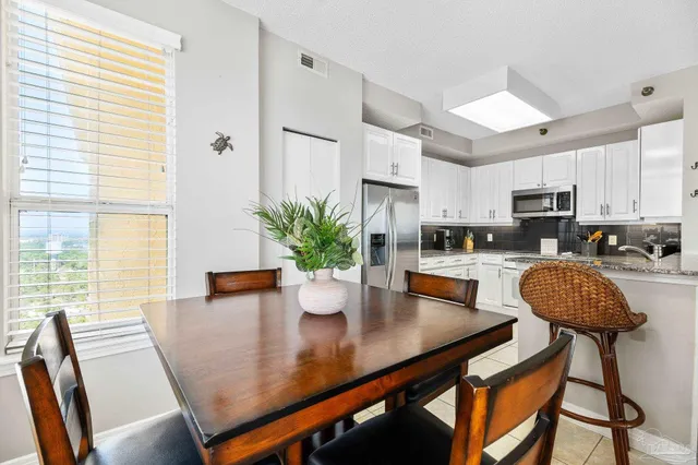 a kitchen with cabinets and chairs