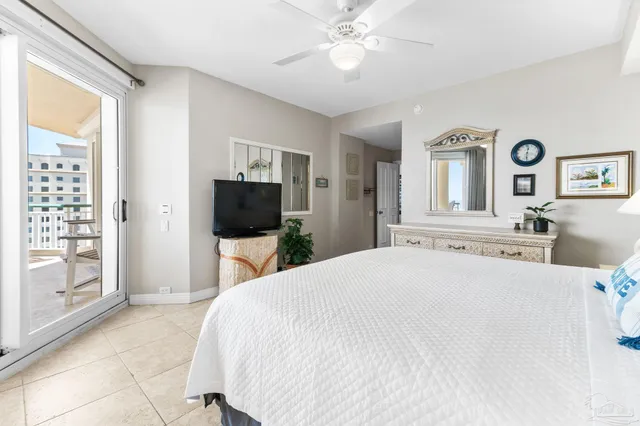 a bedroom with a large bed and a chandelier
