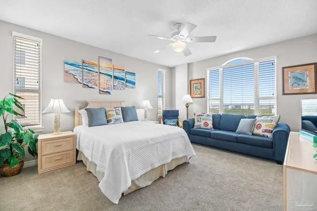 a spacious bedroom with a bed and a mirror on dresser