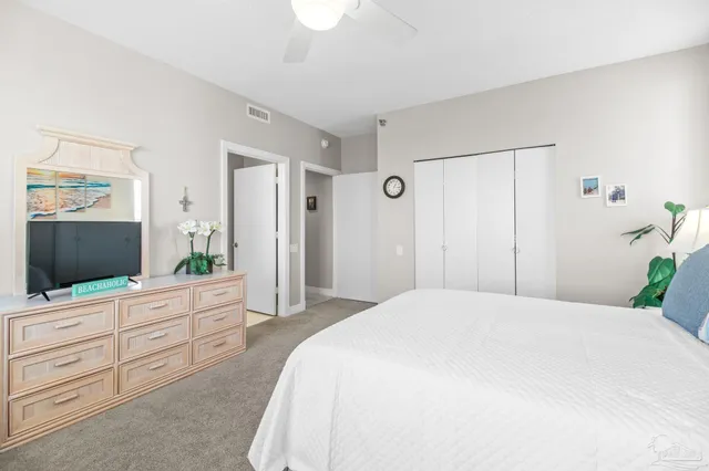 a bedroom with a large bed and a tv