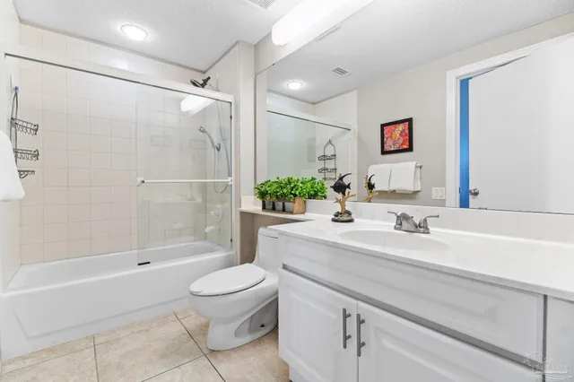 a bedroom with a bed a couch and a chandelier