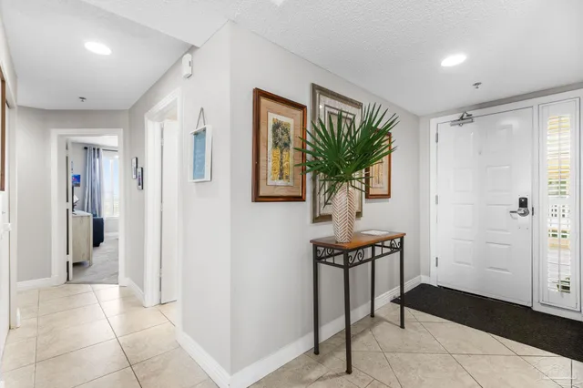 a view of a hallway with bathroom and front door