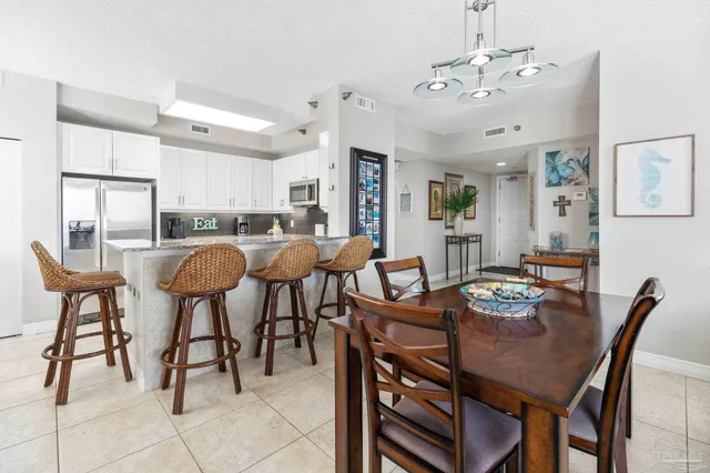 a view of a dining room with furniture and a chandelier