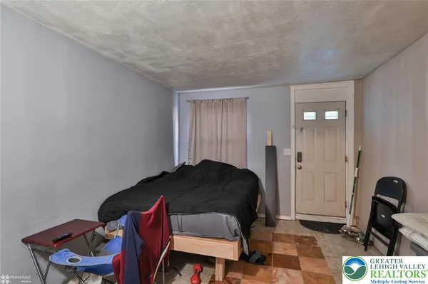 a bedroom with a bed and a chair