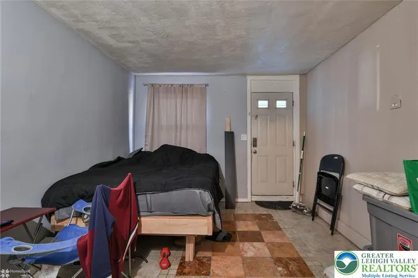 a bedroom with a bed and a mirror