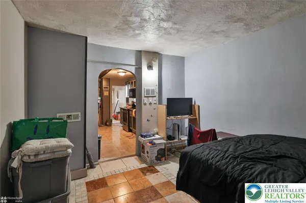 a bedroom with a bed and a mirror