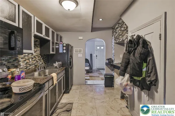 a kitchen with lots of counter top space and stainless steel appliances