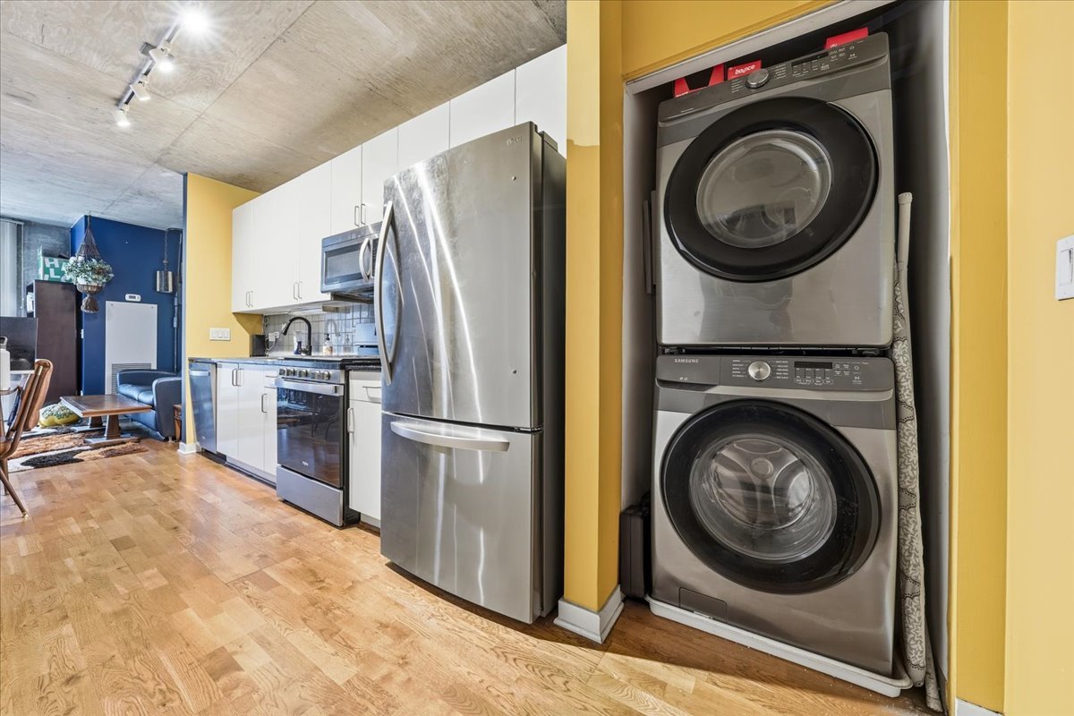 611 South Wells Street, Unit 1110 Chicago, IL 60607 - Photo 6 of 19 a view of a storage and utility room with washer and dryer