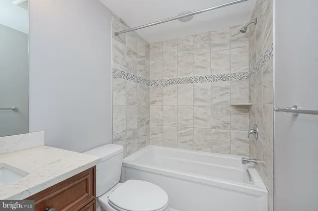 a bathroom with a sink a toilet and a bathtub