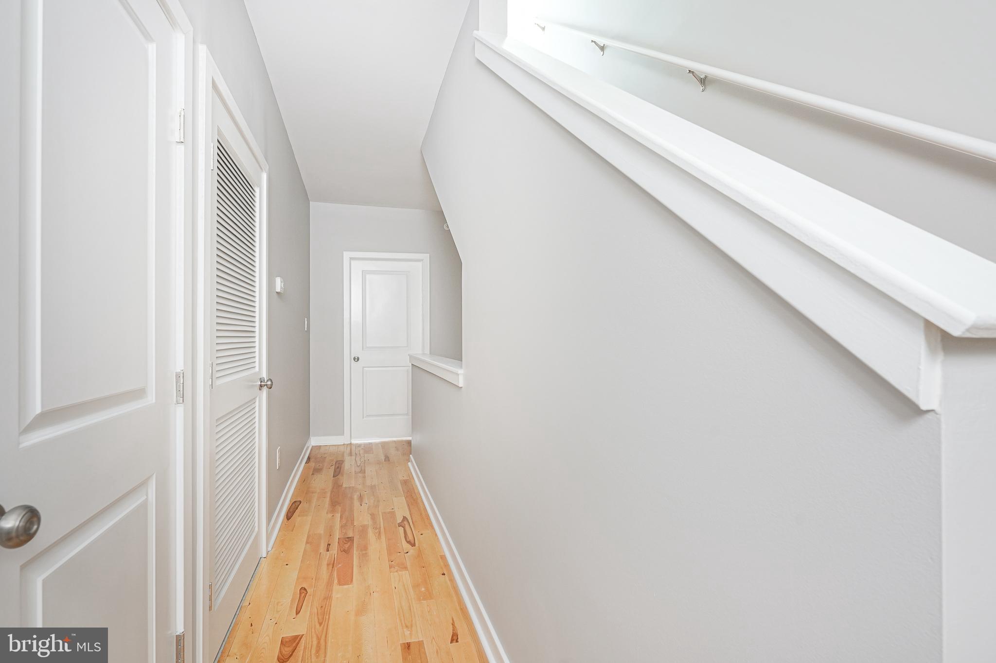 1011 Germantown Avenue, Unit B Philadelphia, PA 19123 - Photo 18 of 34 a view of a hallway with wooden floor and a bathroom