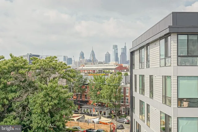 a front view of a building with outdoor space and garden