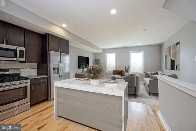 a large kitchen with a large counter top appliances and cabinets