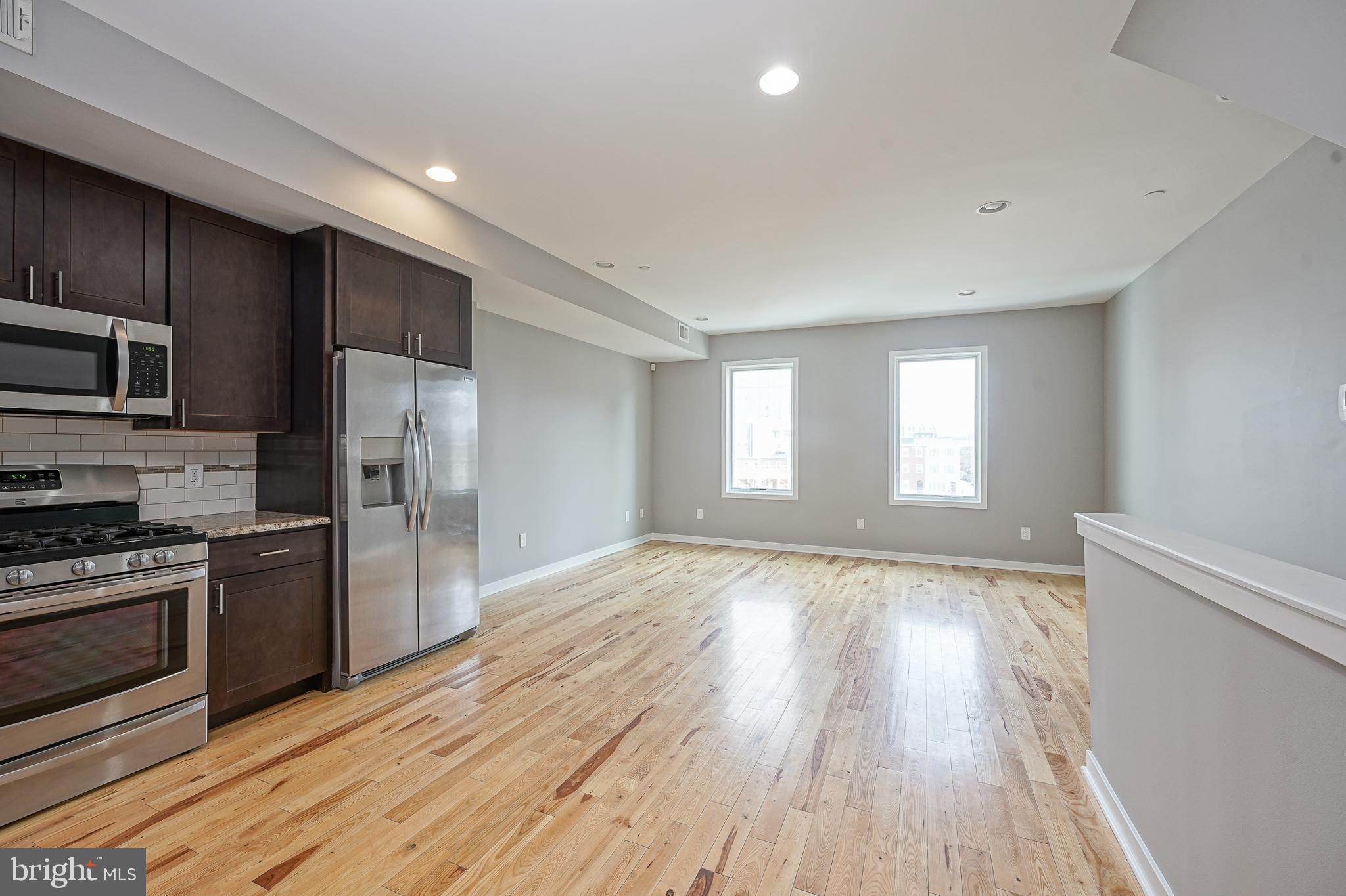 1011 Germantown Avenue, Unit B Philadelphia, PA 19123 - Photo 6 of 34 a view of a kitchen with a stove cabinets and wooden floor