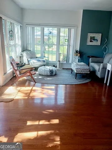 a living room with furniture and wooden floor