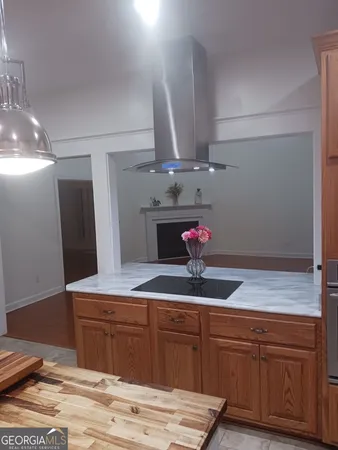 a bathroom with a granite countertop sink a mirror and shower