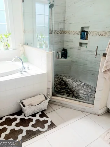 a bathroom with a granite countertop sink a mirror and shower