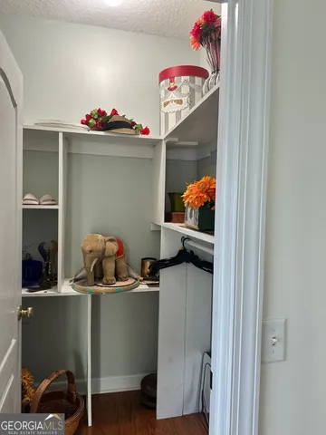 a bathroom with a granite countertop sink a toilet and shower