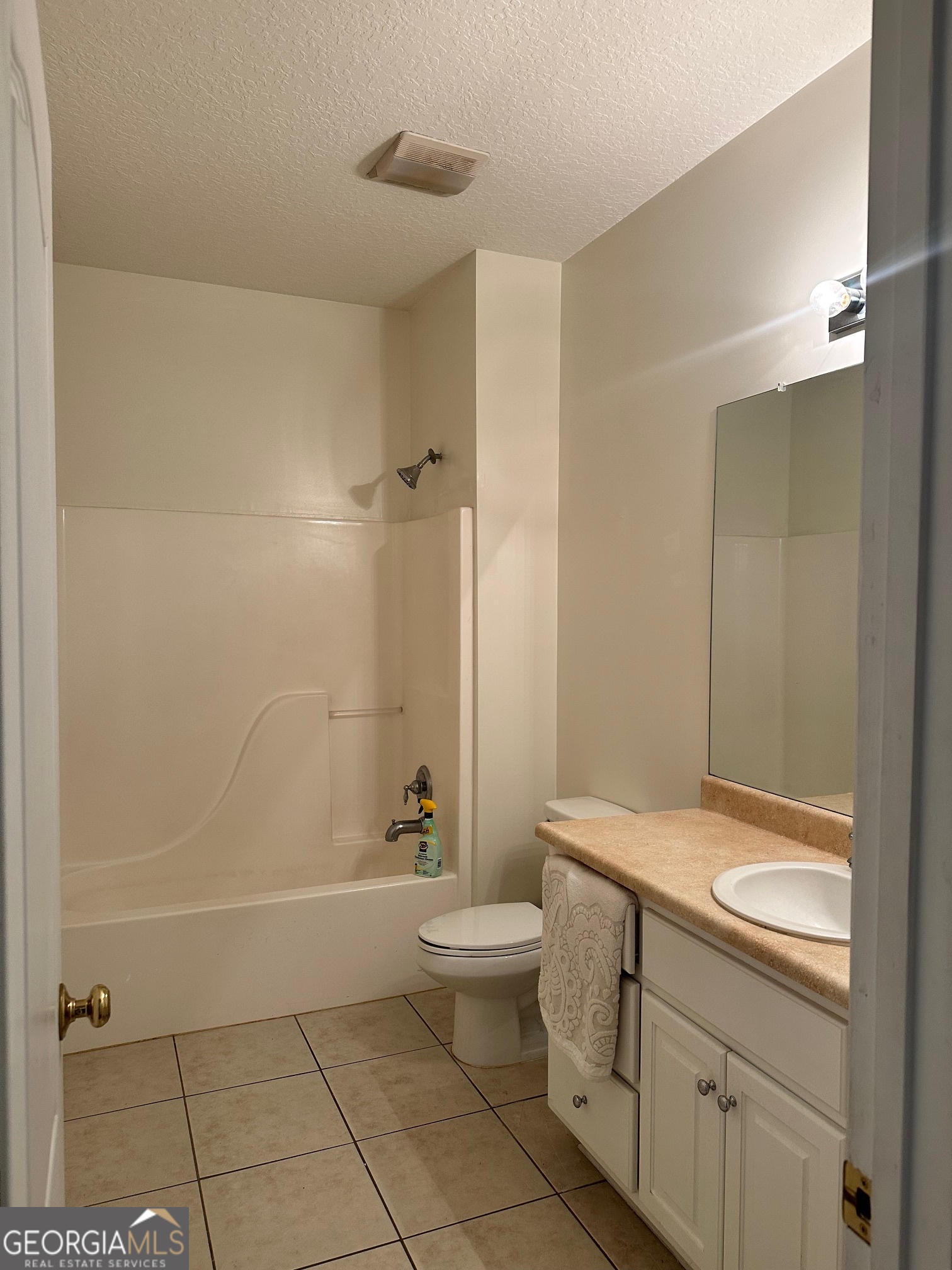 605 Patrick Way Statesboro, GA 30458 - Photo 39 of 58 a bathroom with a granite countertop sink a toilet and shower
