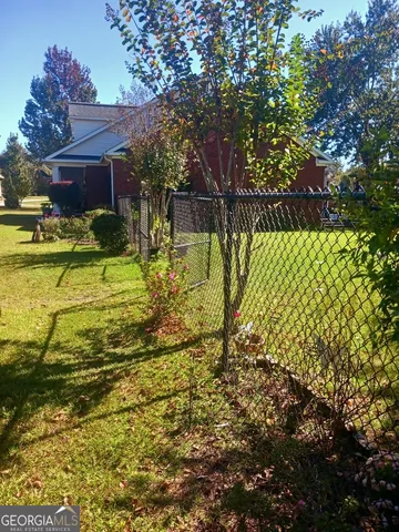 a view of a backyard with sitting area