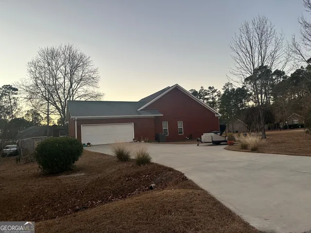 a view of a house with a yard covered in snow