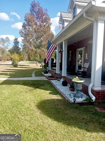 a view of an house with swimming pool garden and patio