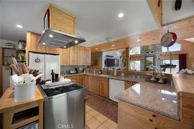 a kitchen with stainless steel appliances granite countertop a sink counter space cabinets and furniture