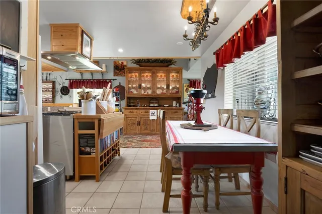 a view of a dining room with furniture and a chandelier