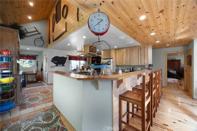 a large kitchen with furniture and a clock