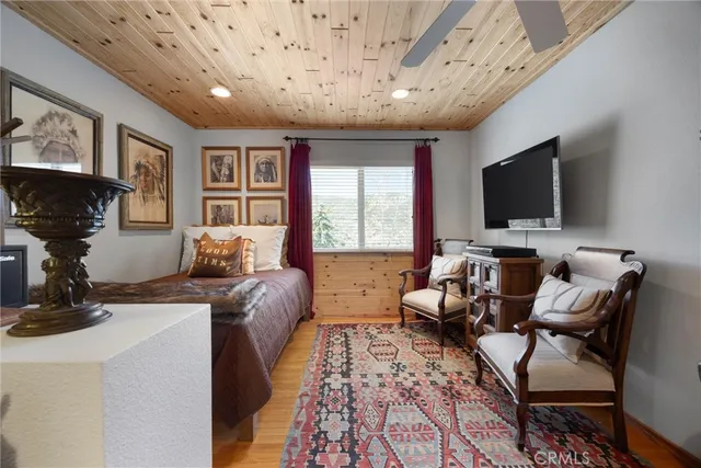 a bedroom with a bed a couch and dresser