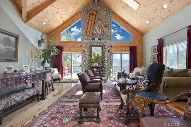 a living room with furniture a chandelier and a dining table