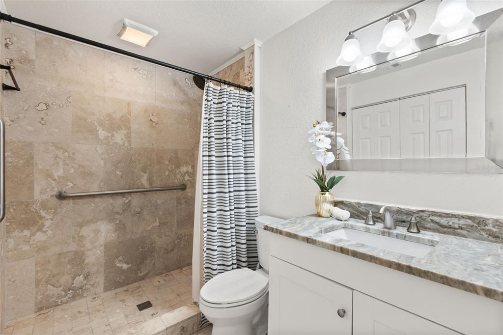 2462 Fort Lane Road Geneva, FL 32732 - Photo 14 of 31 a bathroom with a granite countertop sink a toilet and shower