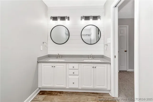 a bathroom with granite countertop a sink and a mirror