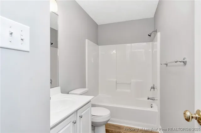 a bathroom with a shower a toilet and a sink