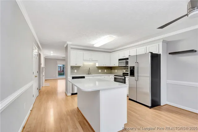 a kitchen with refrigerator and cabinets