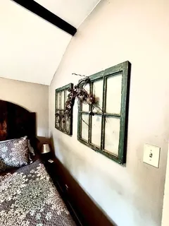 a bed sitting in a bedroom next to a window