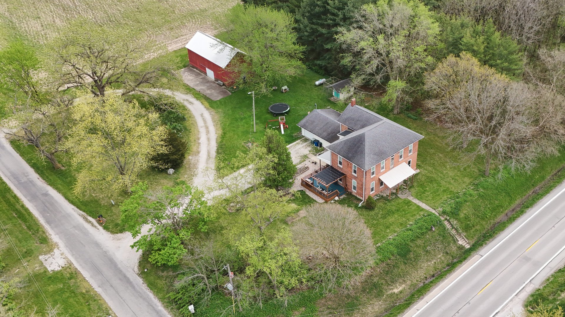 a aerial view of a house with a yard and trees