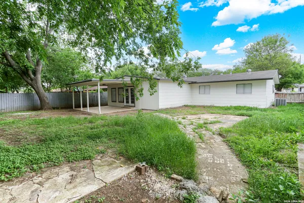 a view of house with backyard and a garden