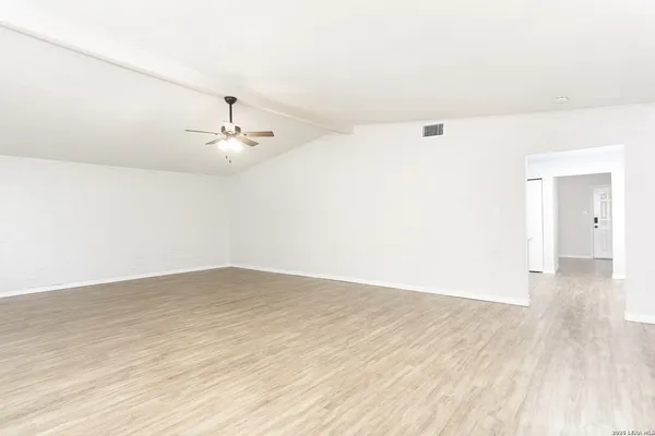 a view of a room with wooden floor