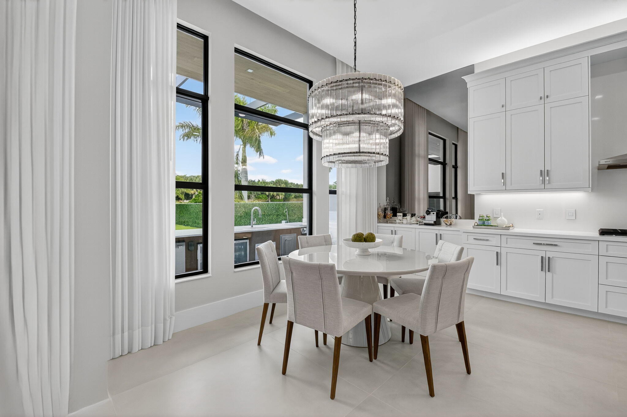 9083 Benedetta Place Boca Raton, FL 33496 - Photo 22 of 112 a view of a dining room with furniture a chandelier and window